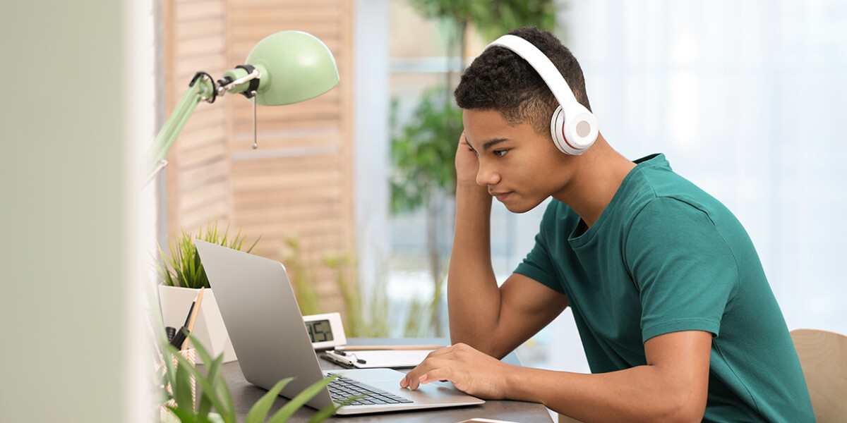 Student on laptop wearing headset