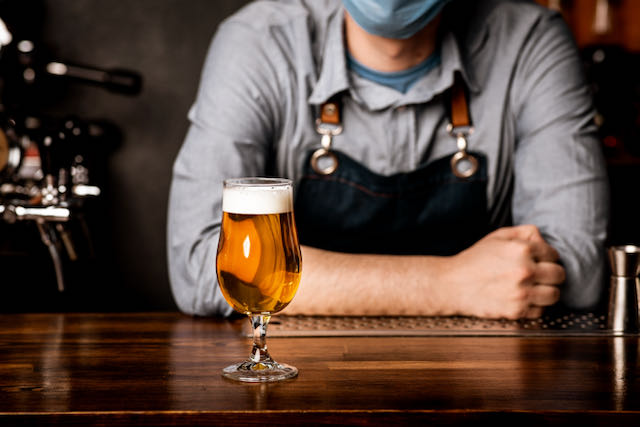 Craft brewer beer on bar man with mask