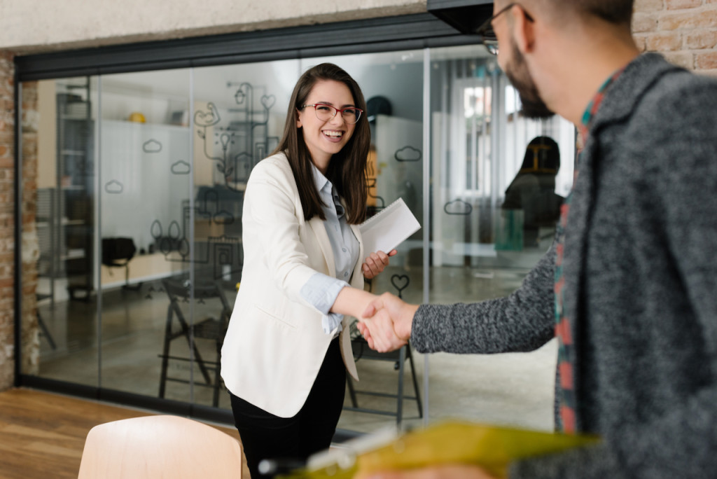 Openly greeting a job recruiter with a firm handshake