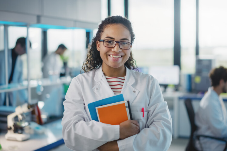 medical laboratory student smiling in lab coat